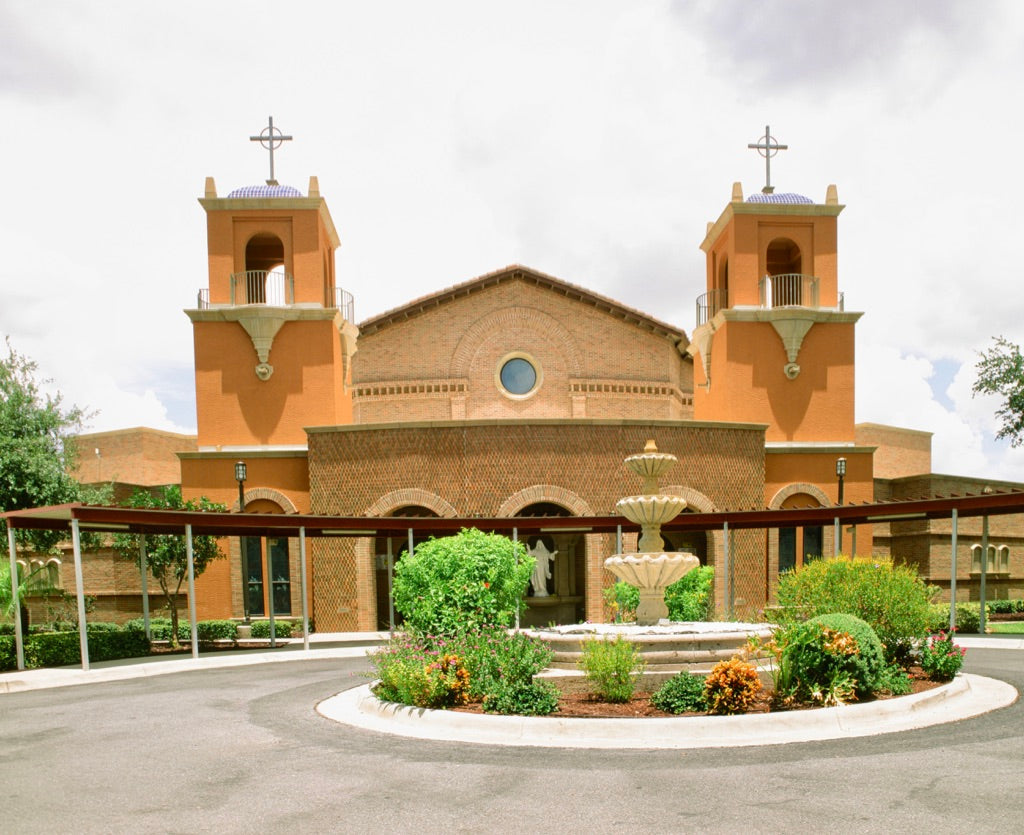 Front of the terracotta twin-tower church numbered 501, with blue tiled cupolas, a three-tier fountain in a circular drive, and a metal pergola, Rio Grande Valley, shot on Fujifilm Fujichrome Velvia 50 120 film, developed in E-6
