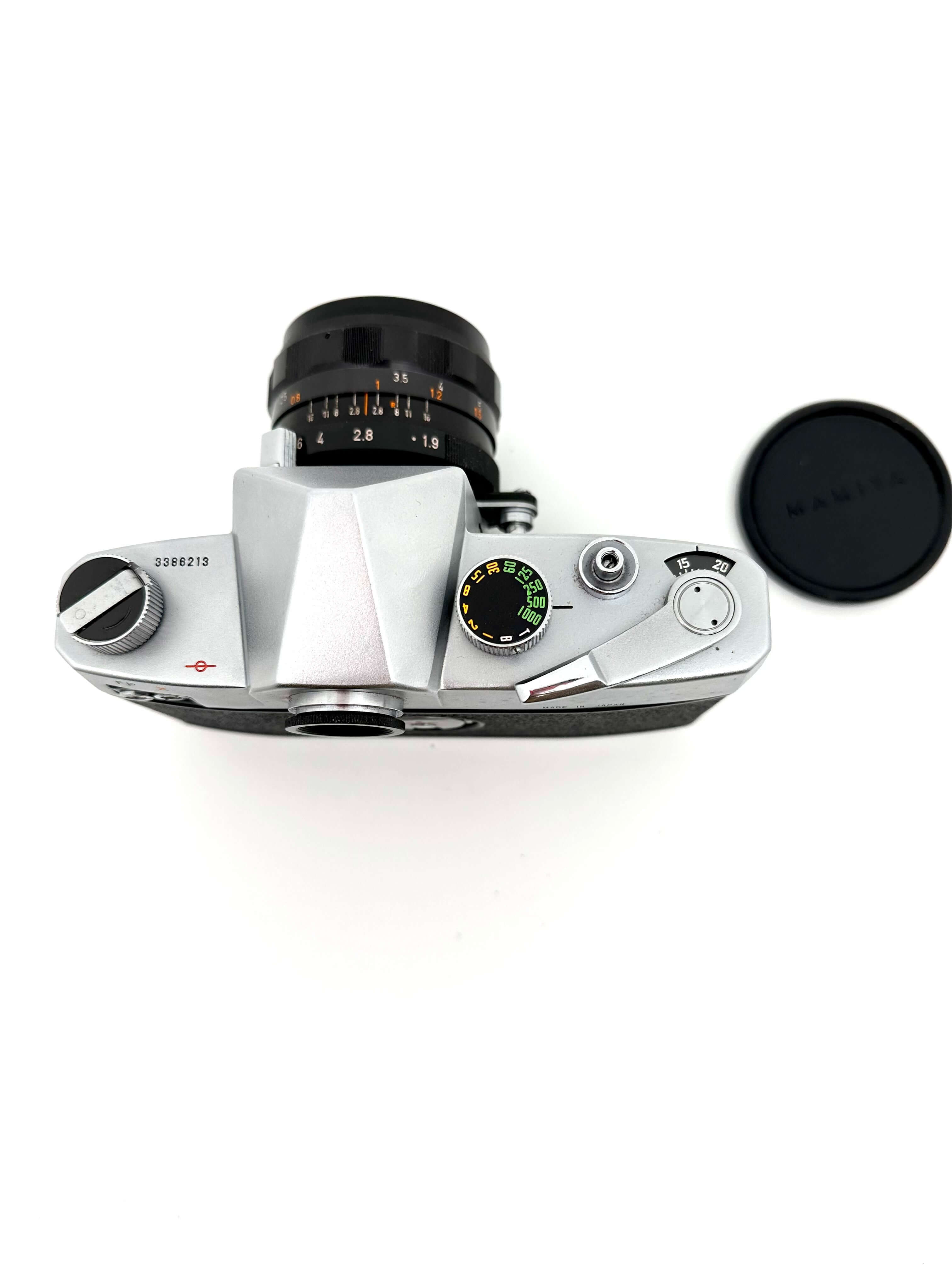 Silver-bodied rangefinder camera with a black lens and matching black shutter speed dial.