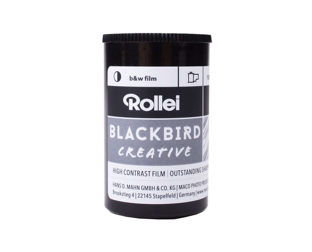 Black cylindrical canister of rollei blackbird creative high contrast black and white film.