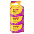Kodak gold 200 film pack, vibrant purple and yellow packaging with three rolls of color negative film.