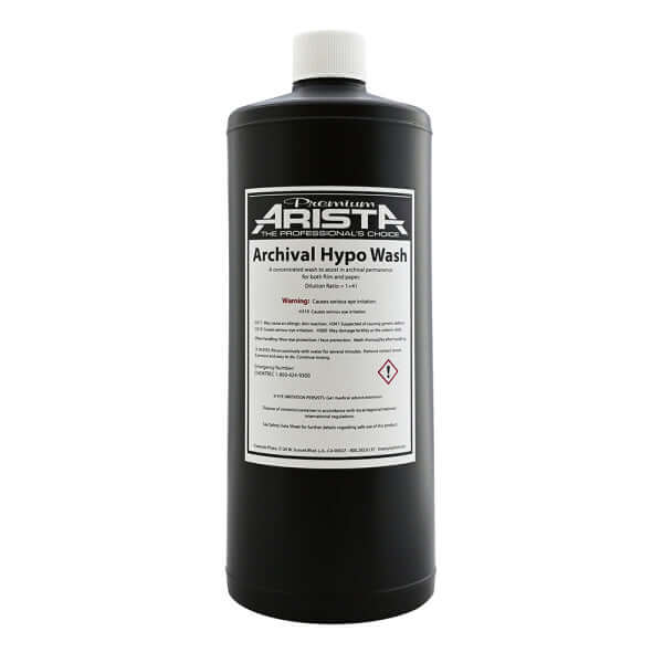 Black plastic bottle with white cap and label reading ’premium arista archival hypo wash.’