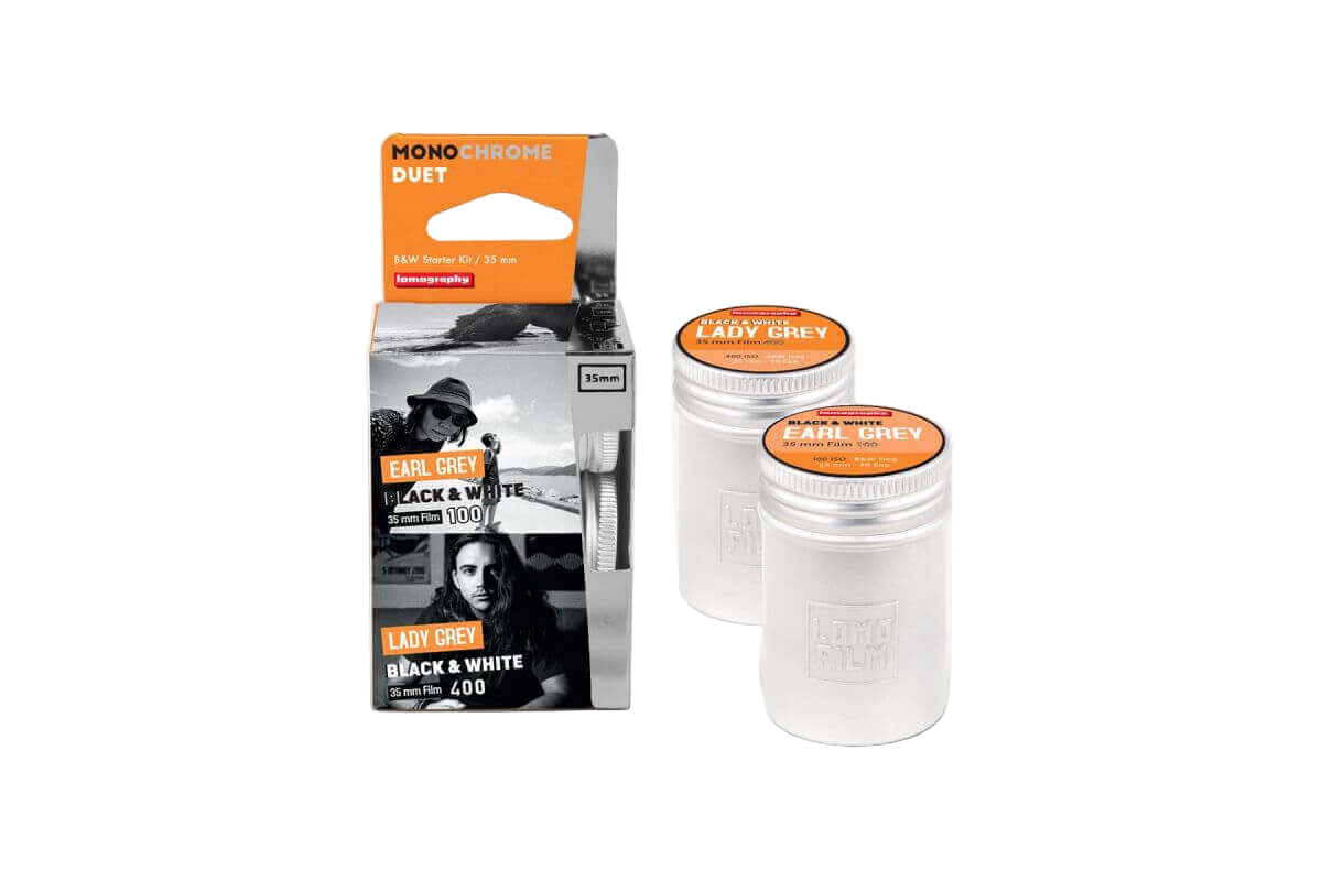 Two transparent cylindrical containers with orange lids, each labeled ’lady grey’ and marked as 35mm black & white film.