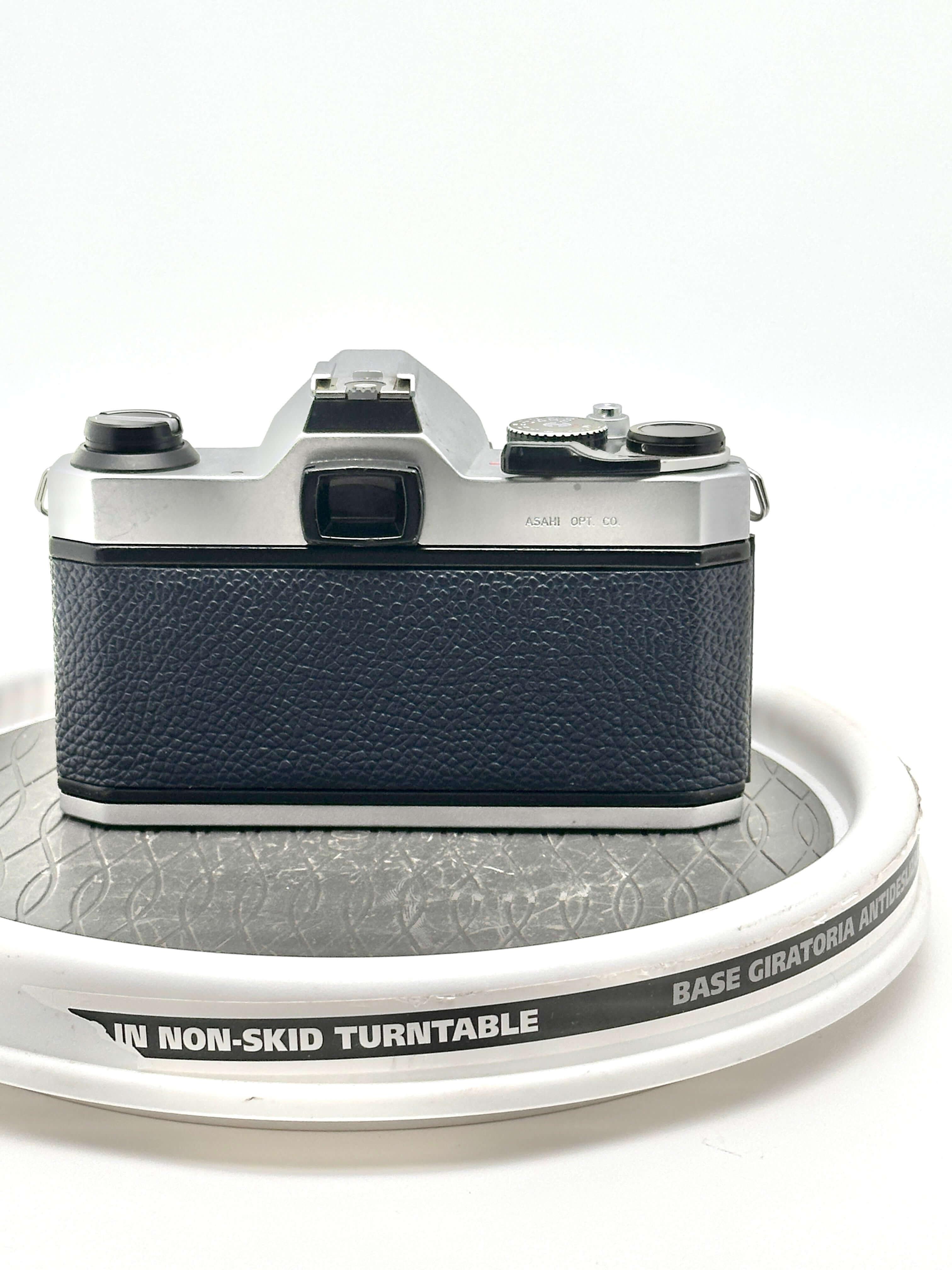 Silver and black vintage camera with textured leather grip.