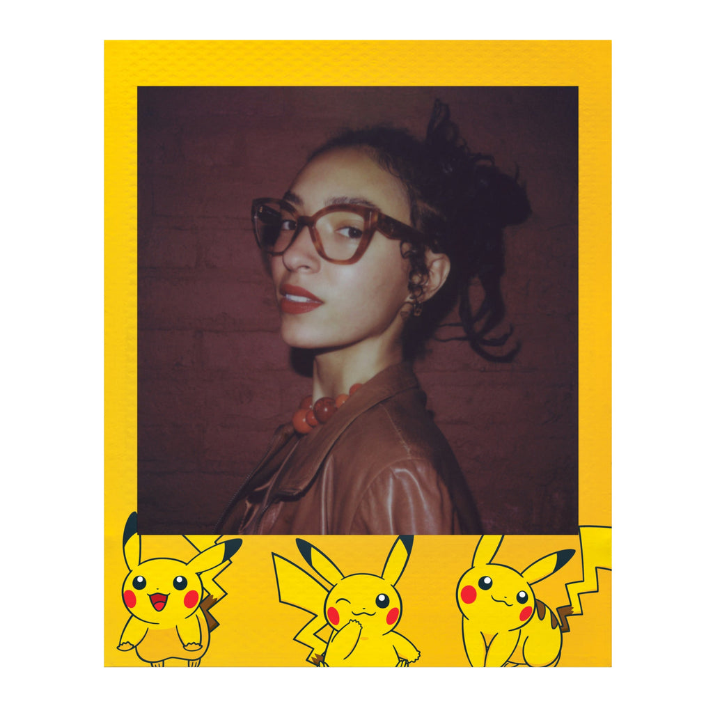 Polaroid Go portrait in a yellow frame lined with Pikachu artwork