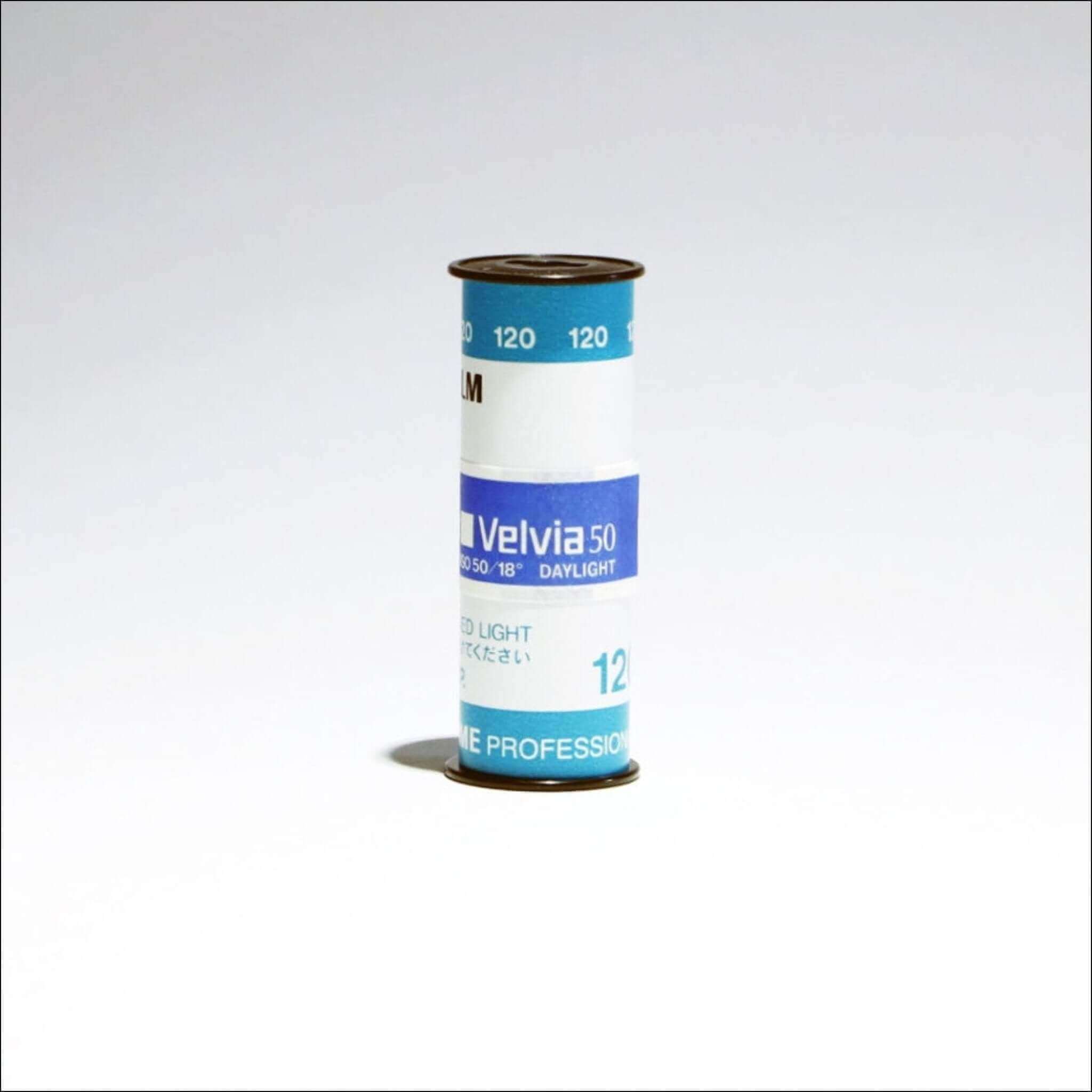 A cylindrical roll of kodak velvia 50 film, featuring a blue and white label with black text.
