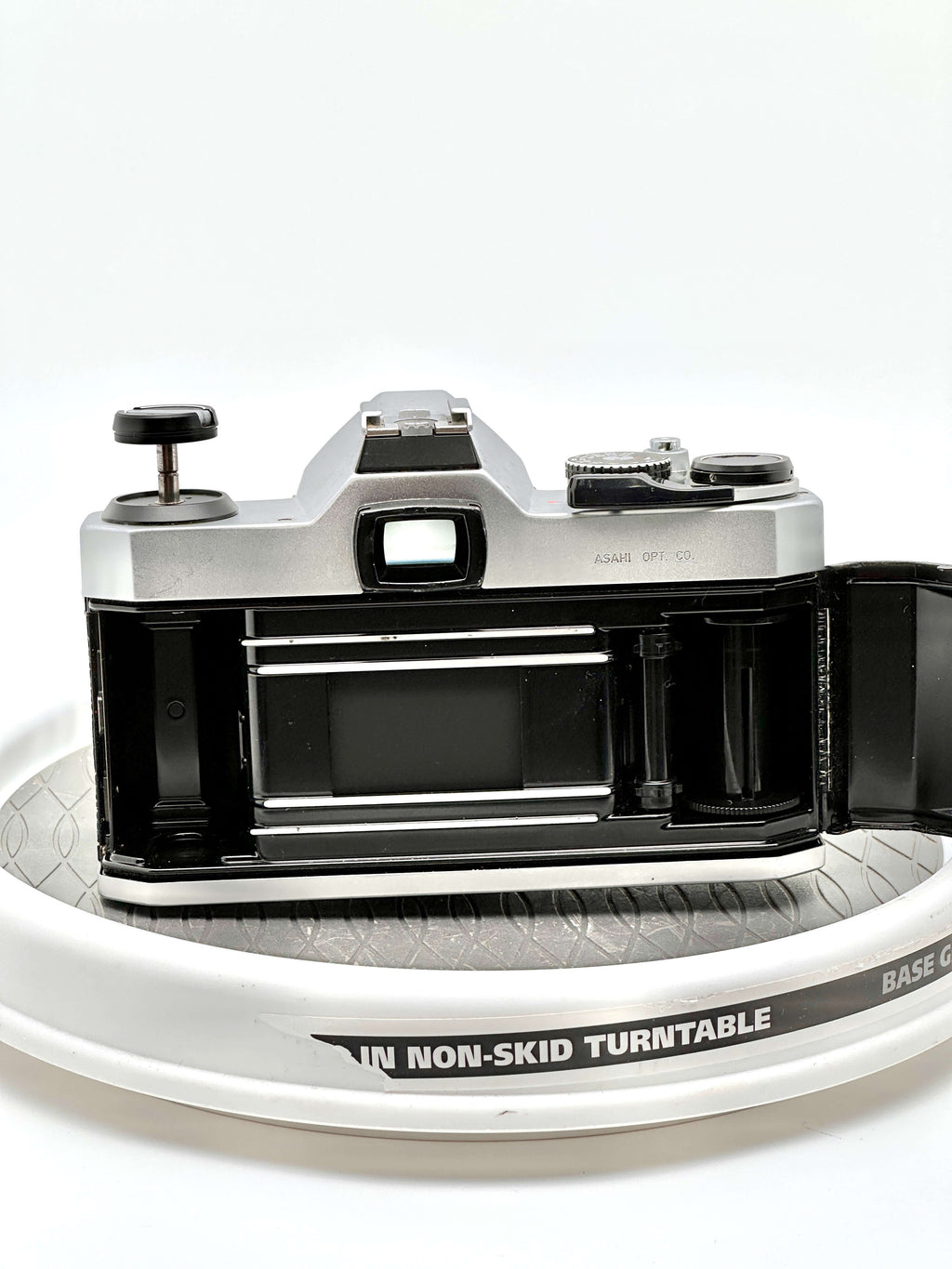 Silver-bodied canon ae-1 film camera with black accents and a visible lens mount.