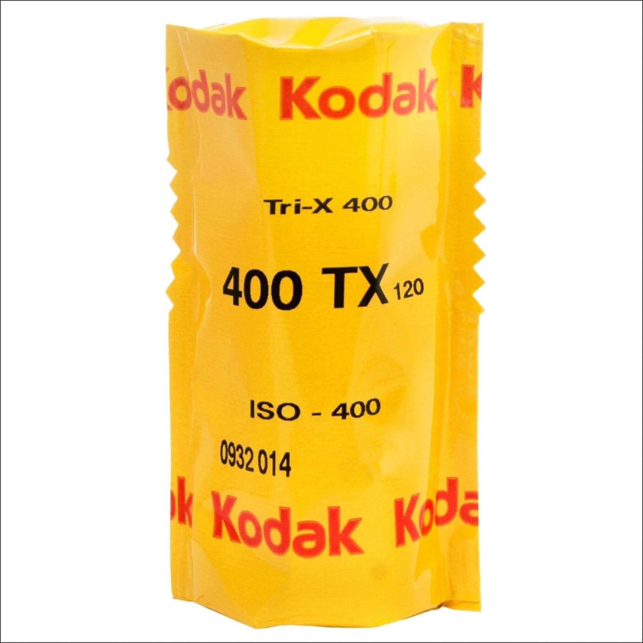 A bright yellow kodak tri-x 400 film roll in its original packaging, labeled with black and red text.