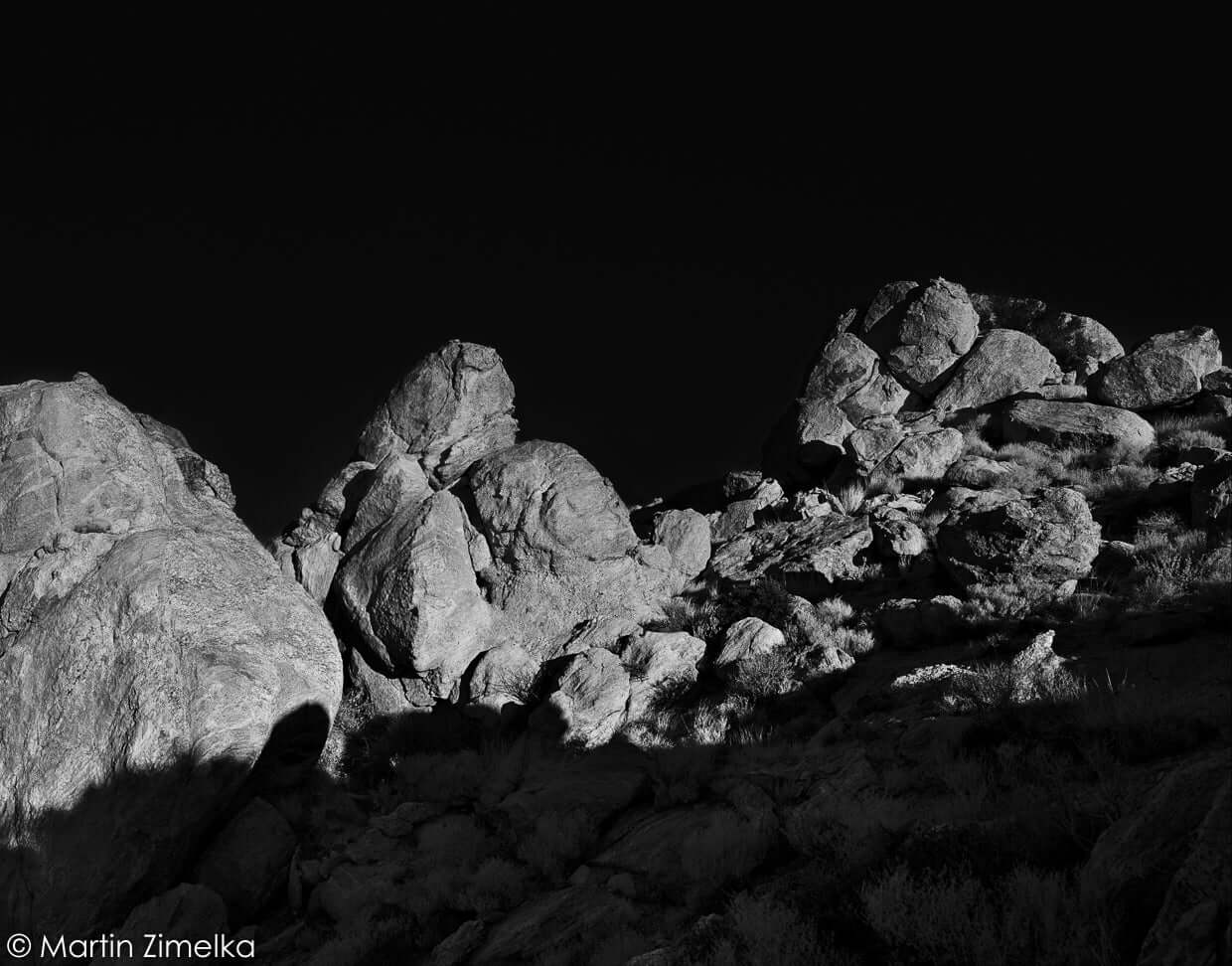 Rugged, unevenly shaped rocks with textured surfaces and sharp edges.