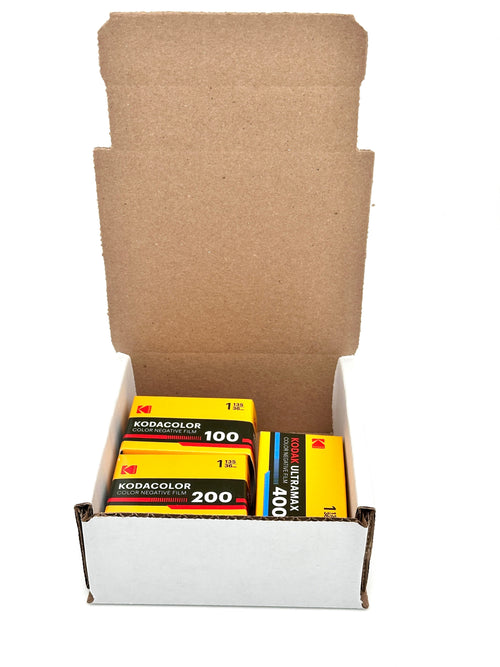 Yellow kodacolor color negative film cartridges in a white cardboard box.