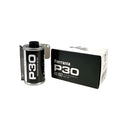 Black ferrania p30 80 iso film canister with silver metallic edges and white text, displayed beside its matching black packaging.