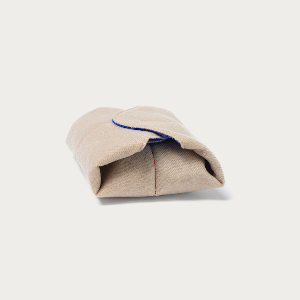 Long Weekend padded camera wrap folded closed into a compact bundle held by velcro corners