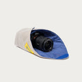 Long Weekend Padded Camera Wrap 16 x 16 inch in Creme Multi folded around a compact mirrorless camera, blue grid lining