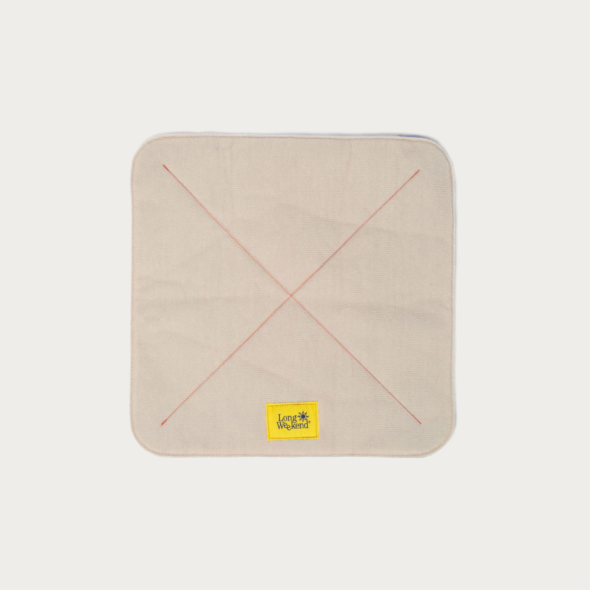 Long Weekend padded camera wrap laid flat, creme exterior with red cross stitching and yellow logo patch