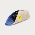 Long Weekend Padded Camera Wrap 19 x 19 inch in Creme Multi wrapped around a film camera, yellow logo patch