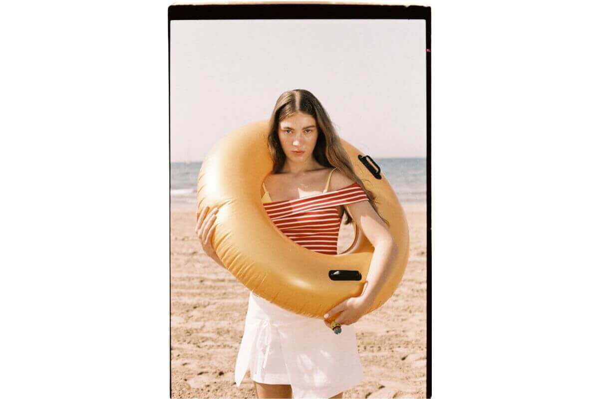 Yellow inflatable swim ring with black handles