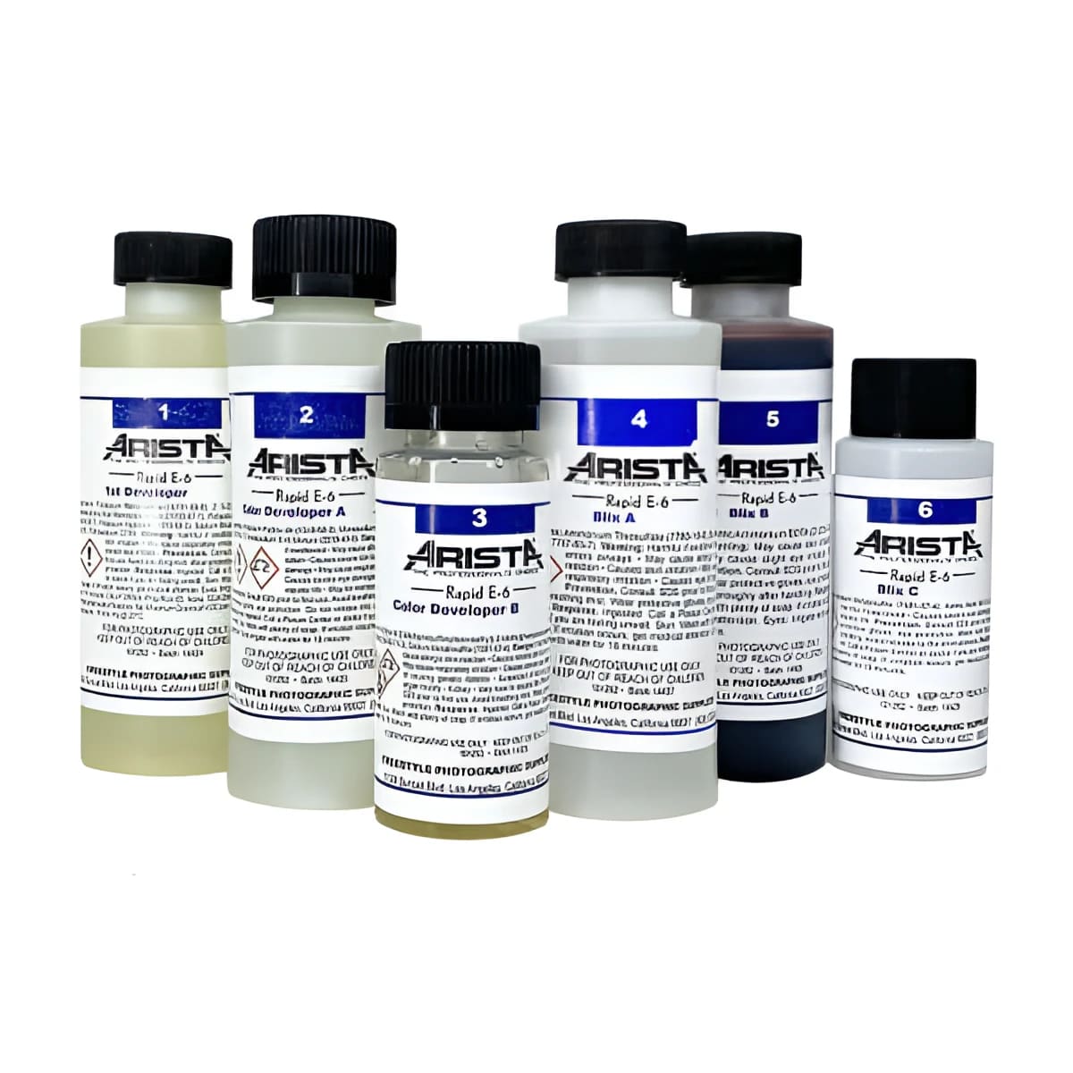 Arista rapid e-6 photographic processing kit featuring six bottles with black caps and white labels, containing developer solutions in varying colors including clear, light yellow, dark purple, and brown.