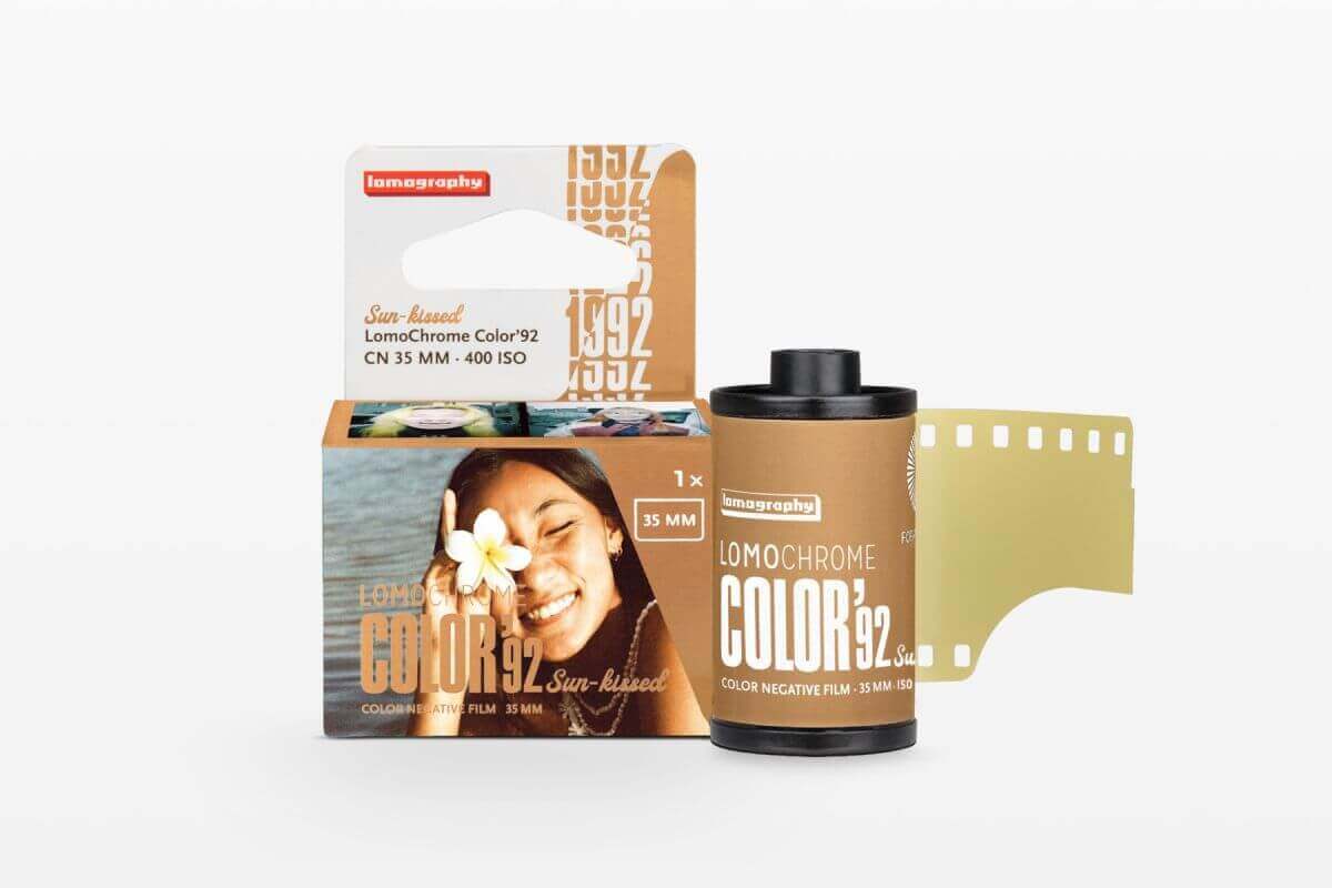 Lomography lomochrome color 92 sun-raised color negative film in a tan cardboard box with black and white text, featuring a smiling woman holding a flower.