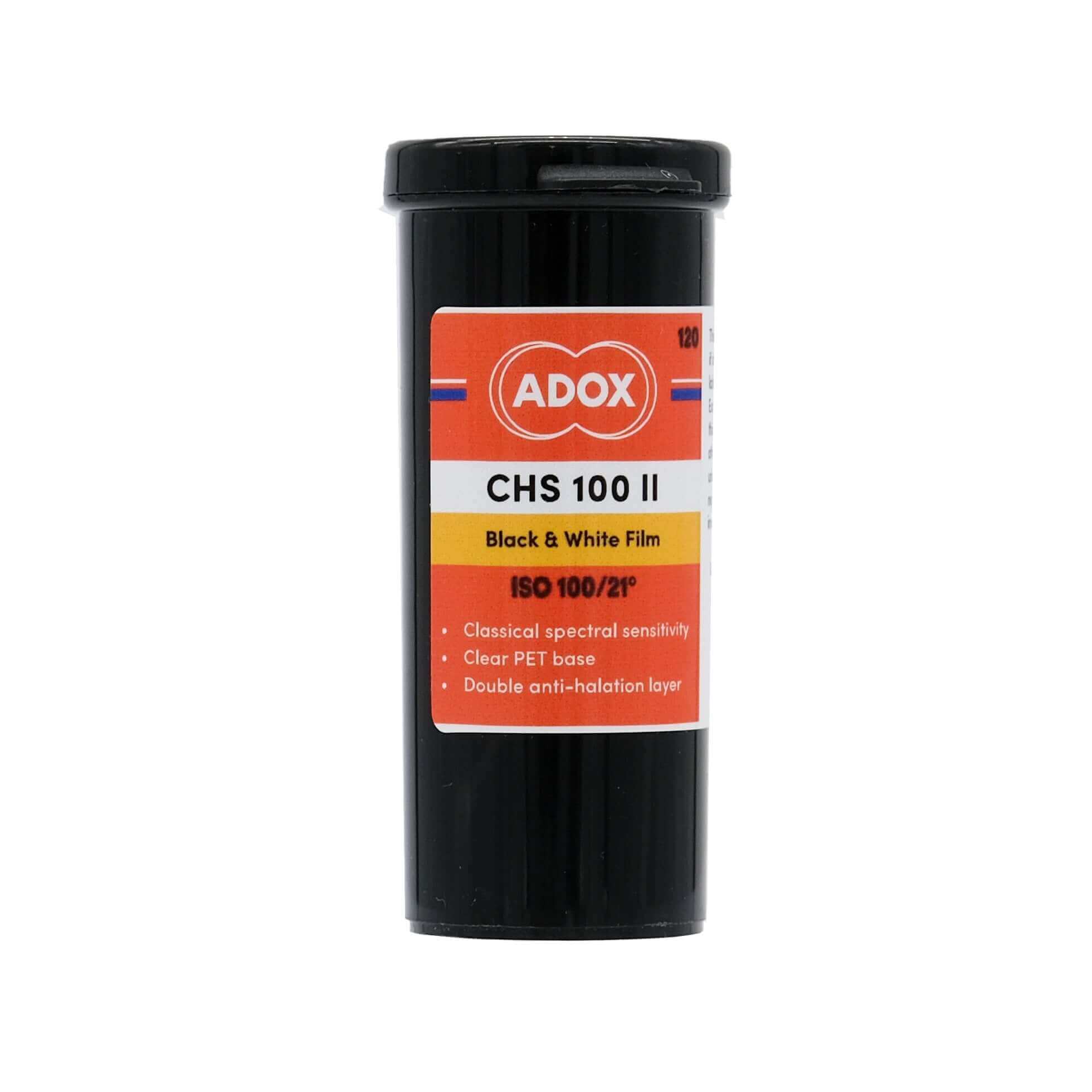 Black cylindrical container of adox chs 100 ii black and white film with an orange, white, and yellow label.