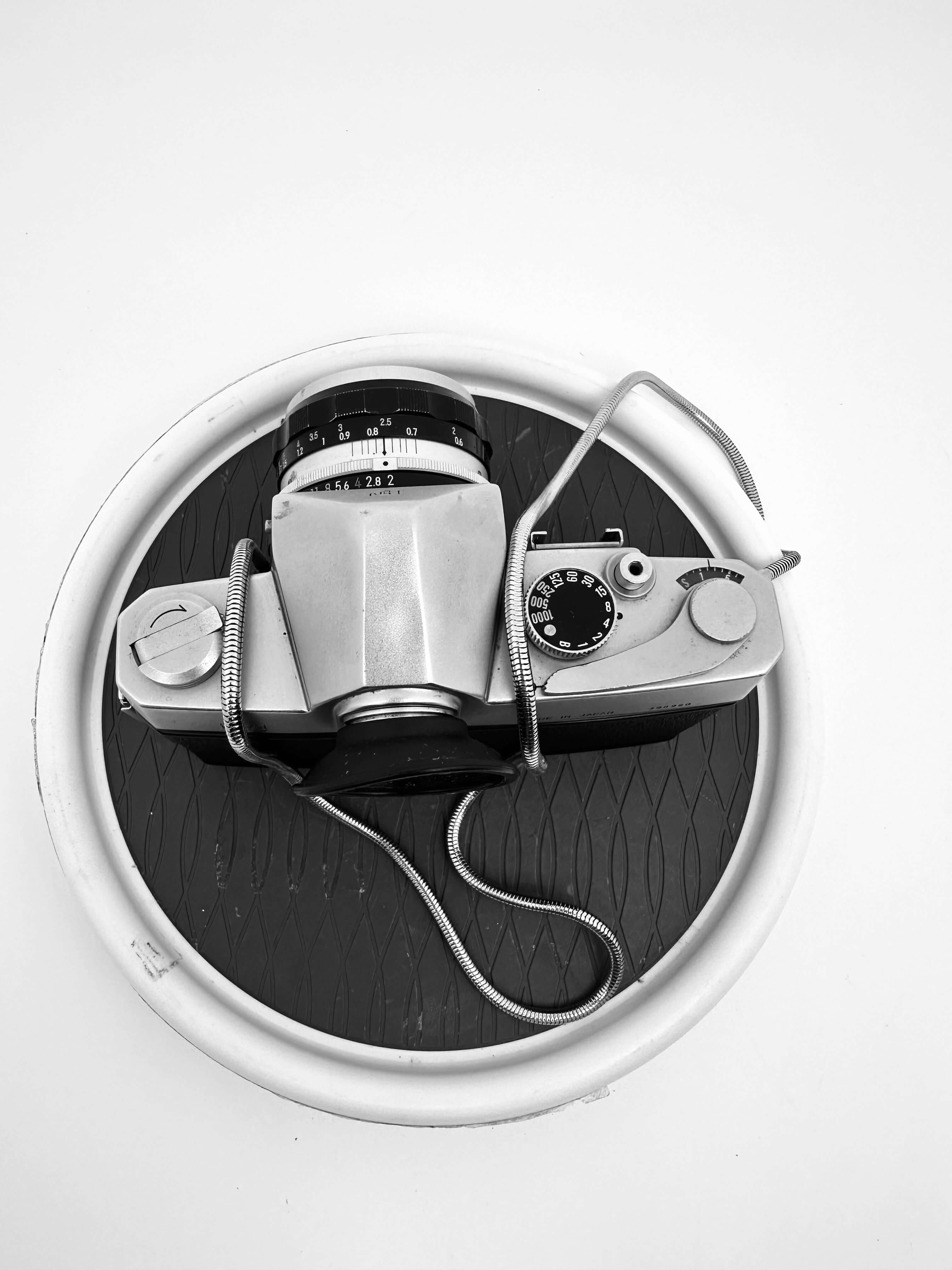 Silver-bodied vintage film camera with a black lens and textured grip.