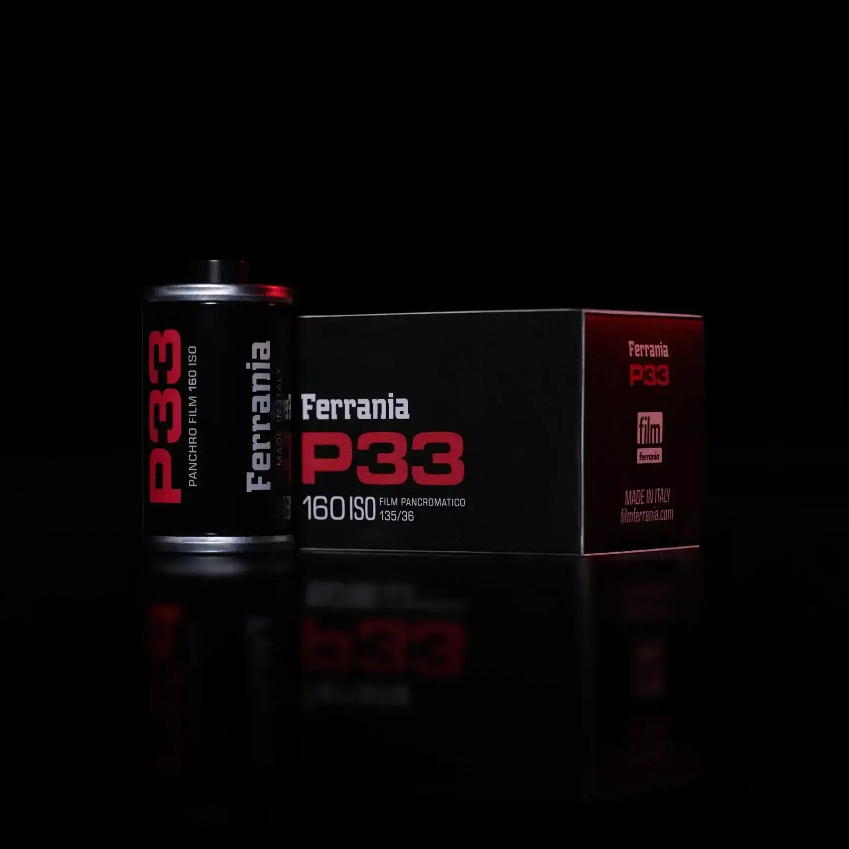 Ferrania p33 panoramic film canister in sleek black with bold red lettering, housed beside its matching box.