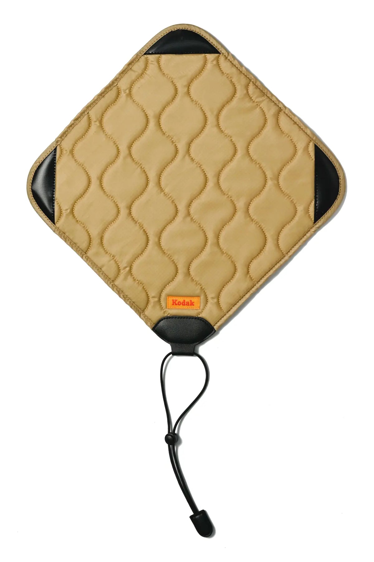 Tan quilted kodak camera strap with black leather accents and a drawstring closure.