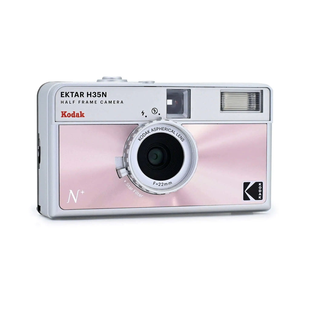 Pink and silver kodak ektar h35n half-frame camera with a 22mm aspherical lens.