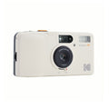 Cream-colored kodak snapie a1 instant camera with a black lens and orange accents.