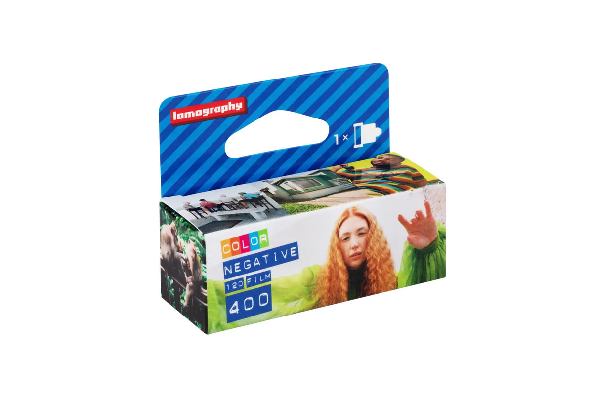 Lomography color negative 120 film, 400 iso, in a vibrant blue and green cardboard box with photographic imagery.