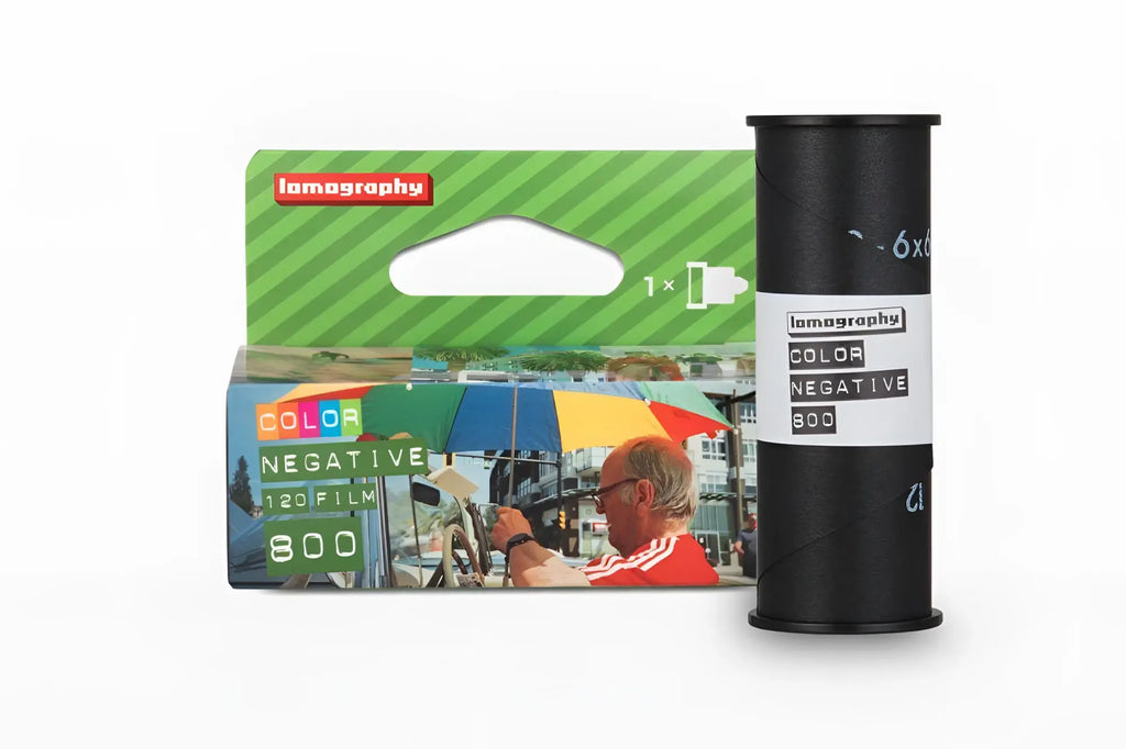 Lomography color negative 800 film in a green and blue box with black roll, featuring vibrant street scene imagery.