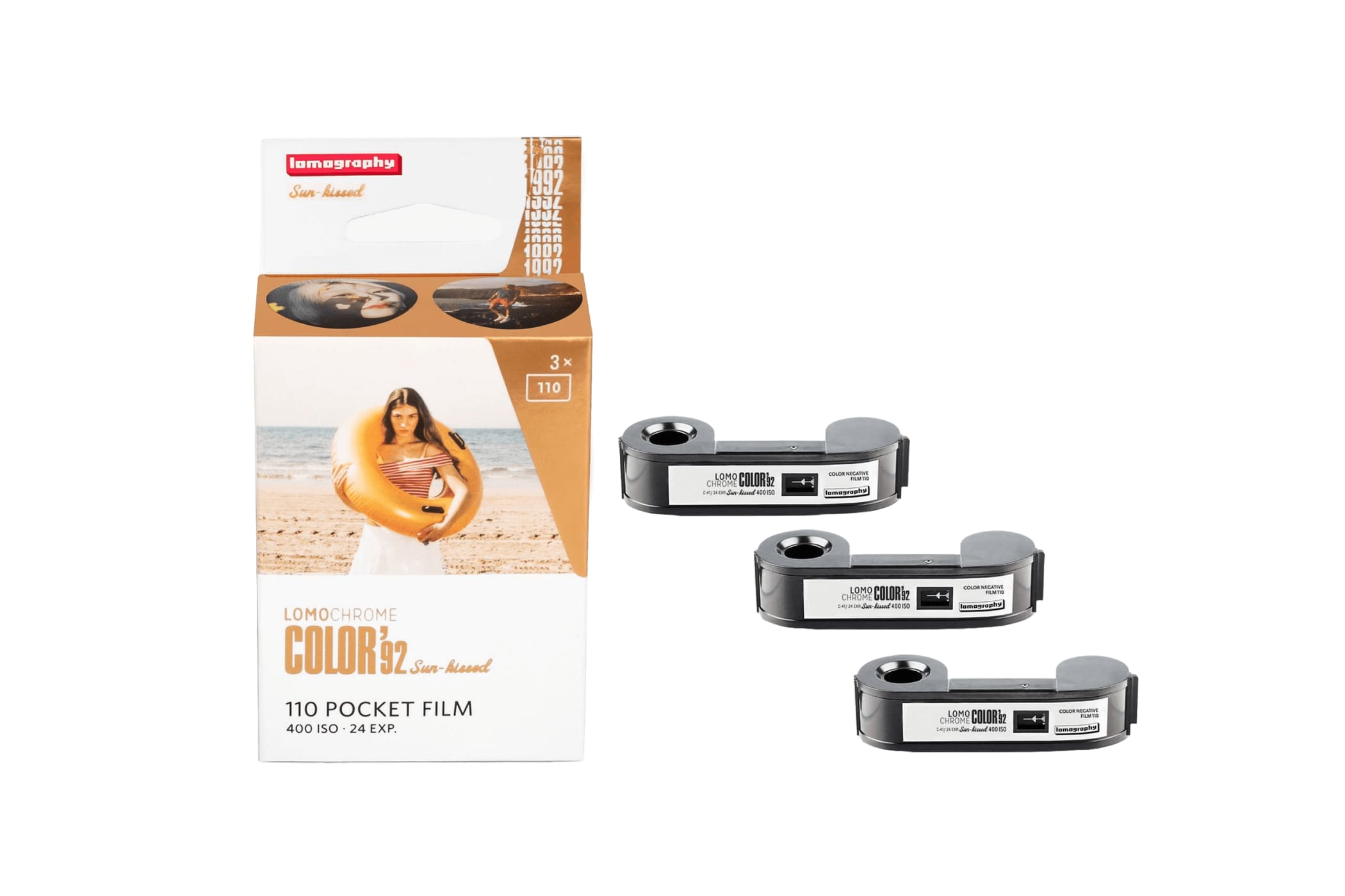 Lomography color 32 sun-kissed 110 pocket film in a white and orange box with three black film reels beside it.