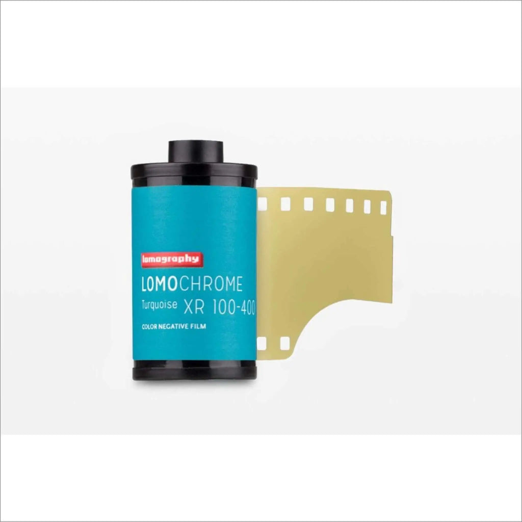 Turquoise lomography lomochrome xr 100-400 color negative film roll with a black cap and exposed golden-yellow strip.