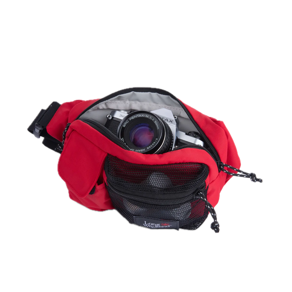 Long weekend santa fe camera bag chili red weave nylon waist pack with black mesh pocket holding silver pentax camera