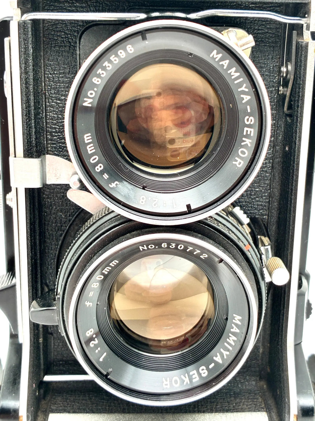 Vintage Mamiya-Sekor camera with two lenses on a white background