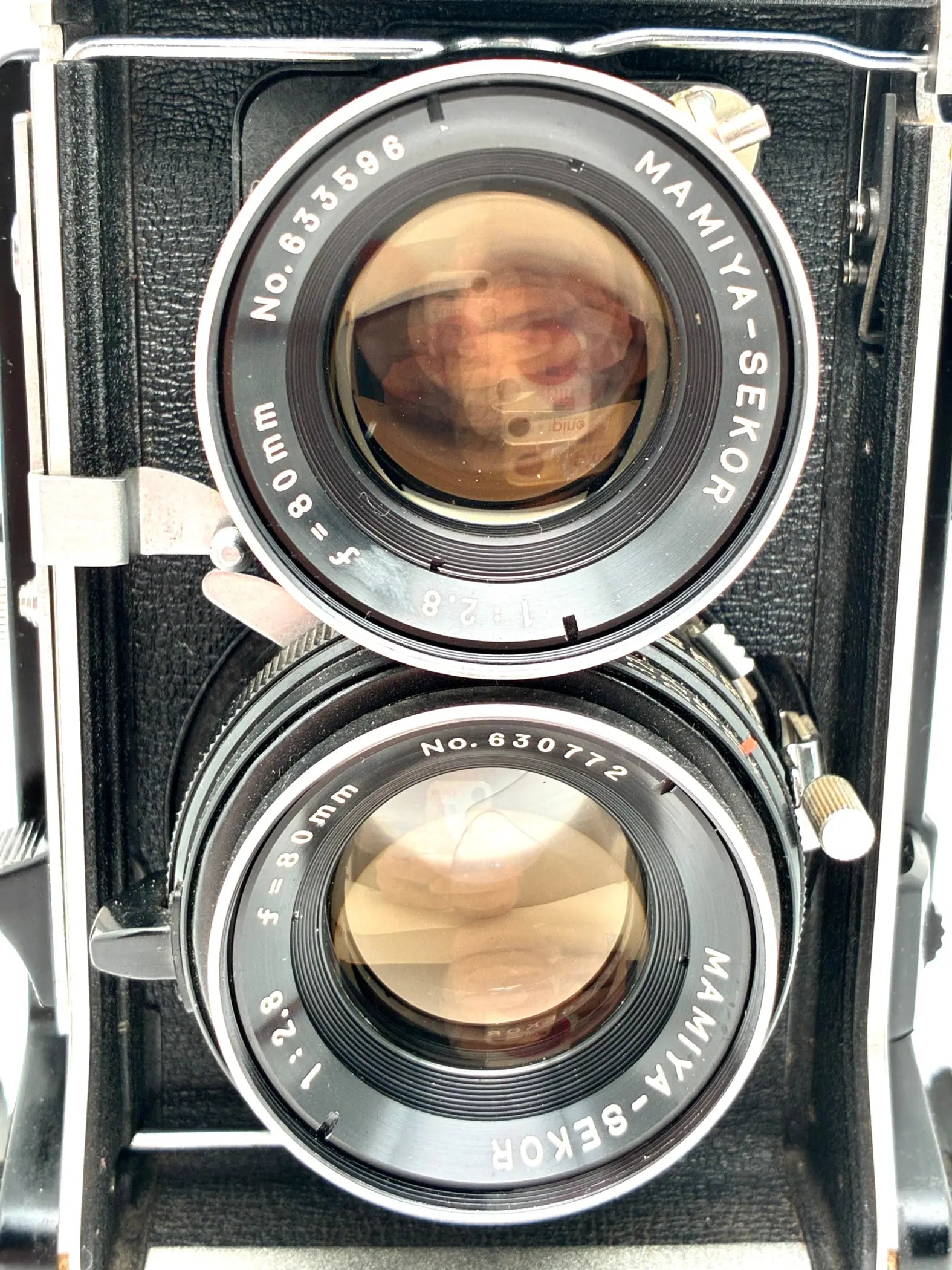 Vintage Mamiya-Sekor camera with two lenses on a white background