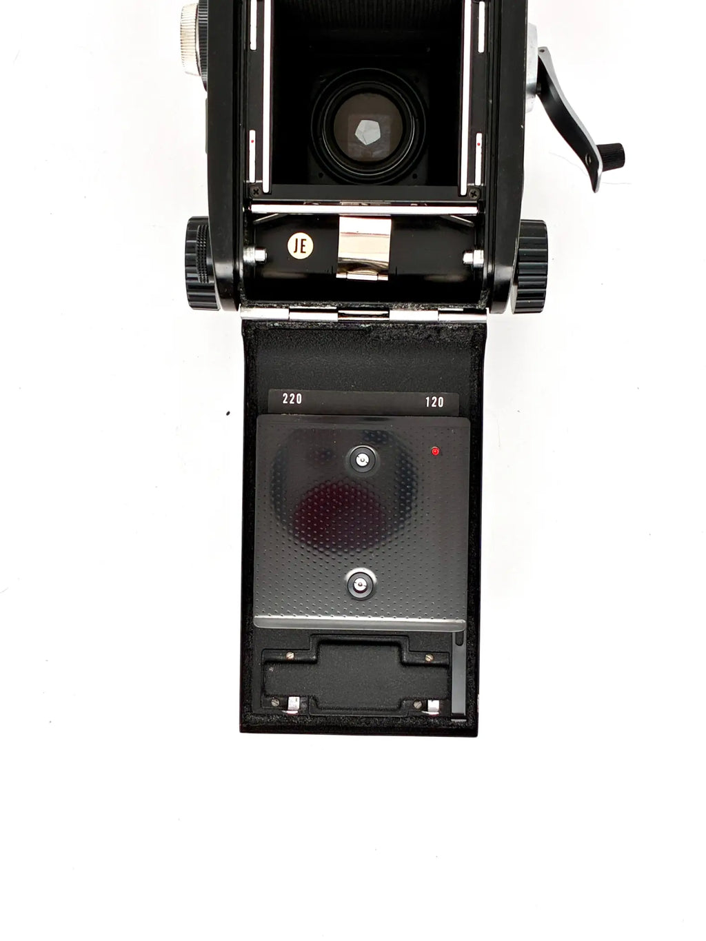 Vintage camera with open back on a white background