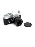Silver and black mamiya film camera with a mounted lens.