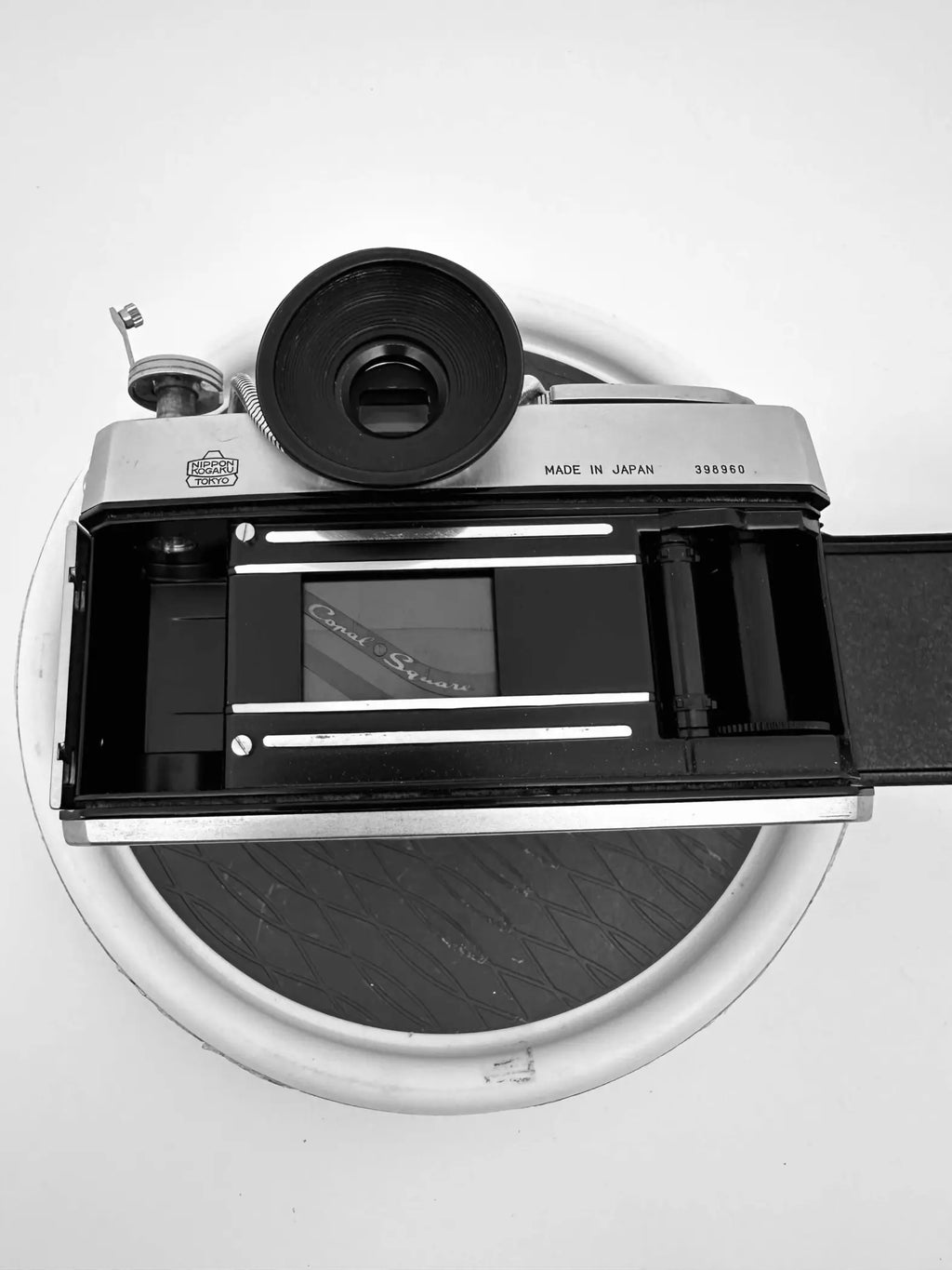 Silver-bodied canon camera with black lens and viewfinder, featuring a classic rangefinder design.