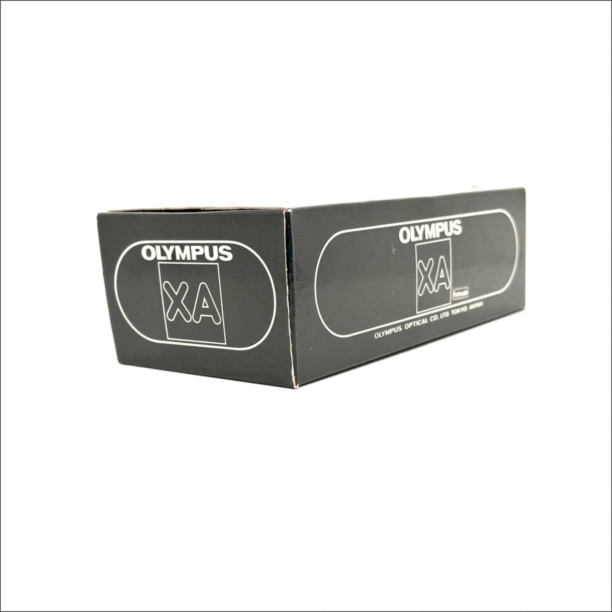 Black rectangular box with white ’olympus xa’ branding and a small logo, featuring the text ’olympus optical co., ltd.
