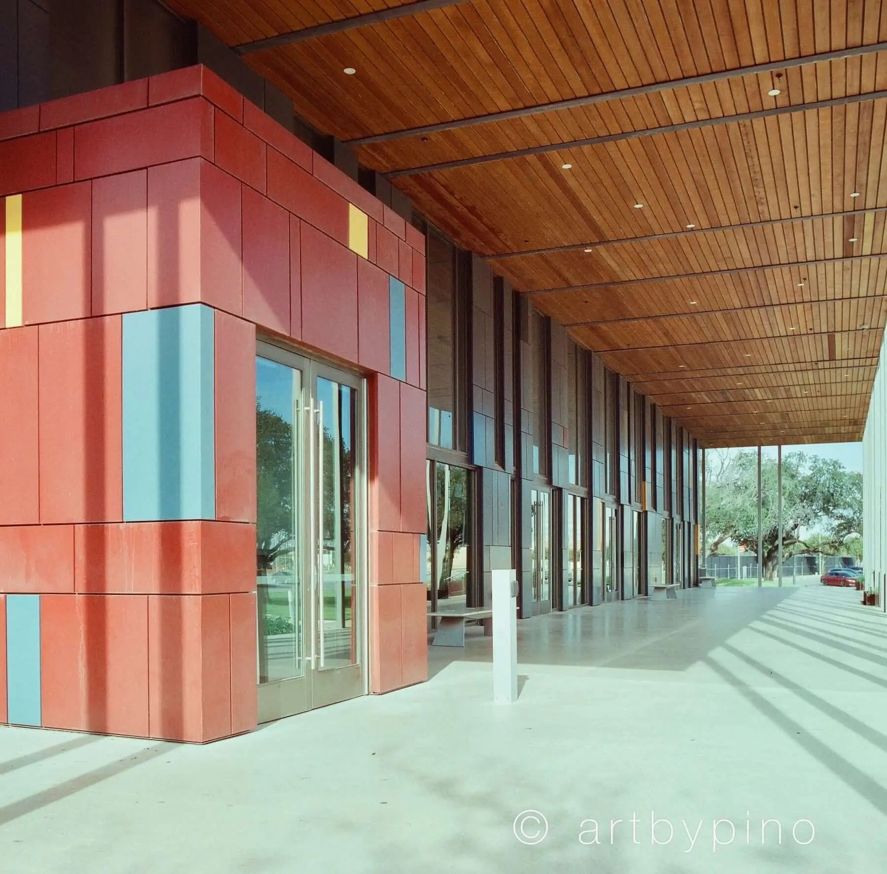 The building features a modern facade with bold red, blue, and yellow panels arranged in geometric patterns.