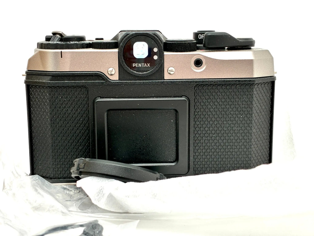 Black and silver pentax k-70 half-frame film camera body with textured grip for 35mm half-frame film use