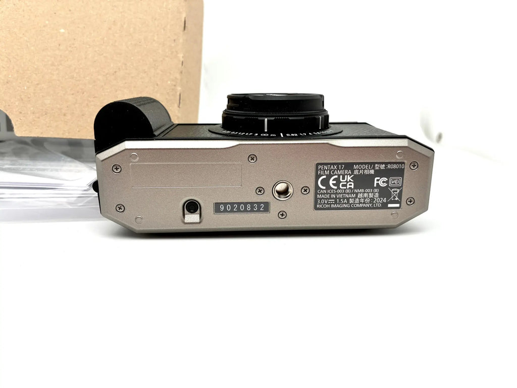 Silver-bodied pentax 67 half-frame film camera with black top plate and lens mount for 35mm half-frame film use