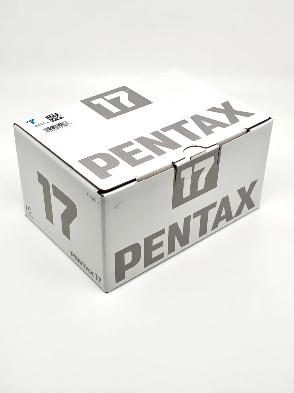 White cardboard box with gray pentax 17 branding for 35mm half-frame film camera open box with original package and docs