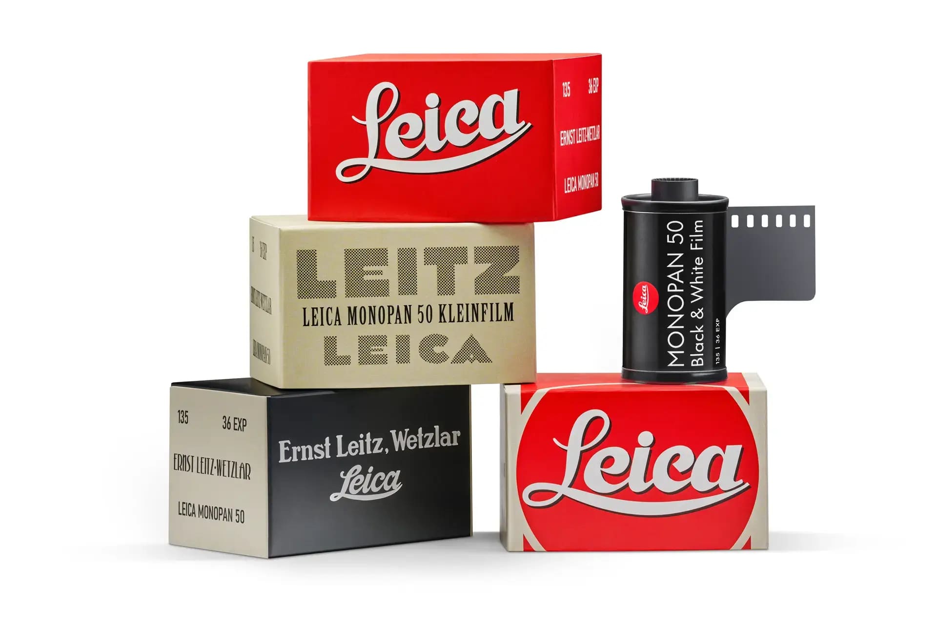Red and beige leica film boxes with black-and-white photographic film canister.
