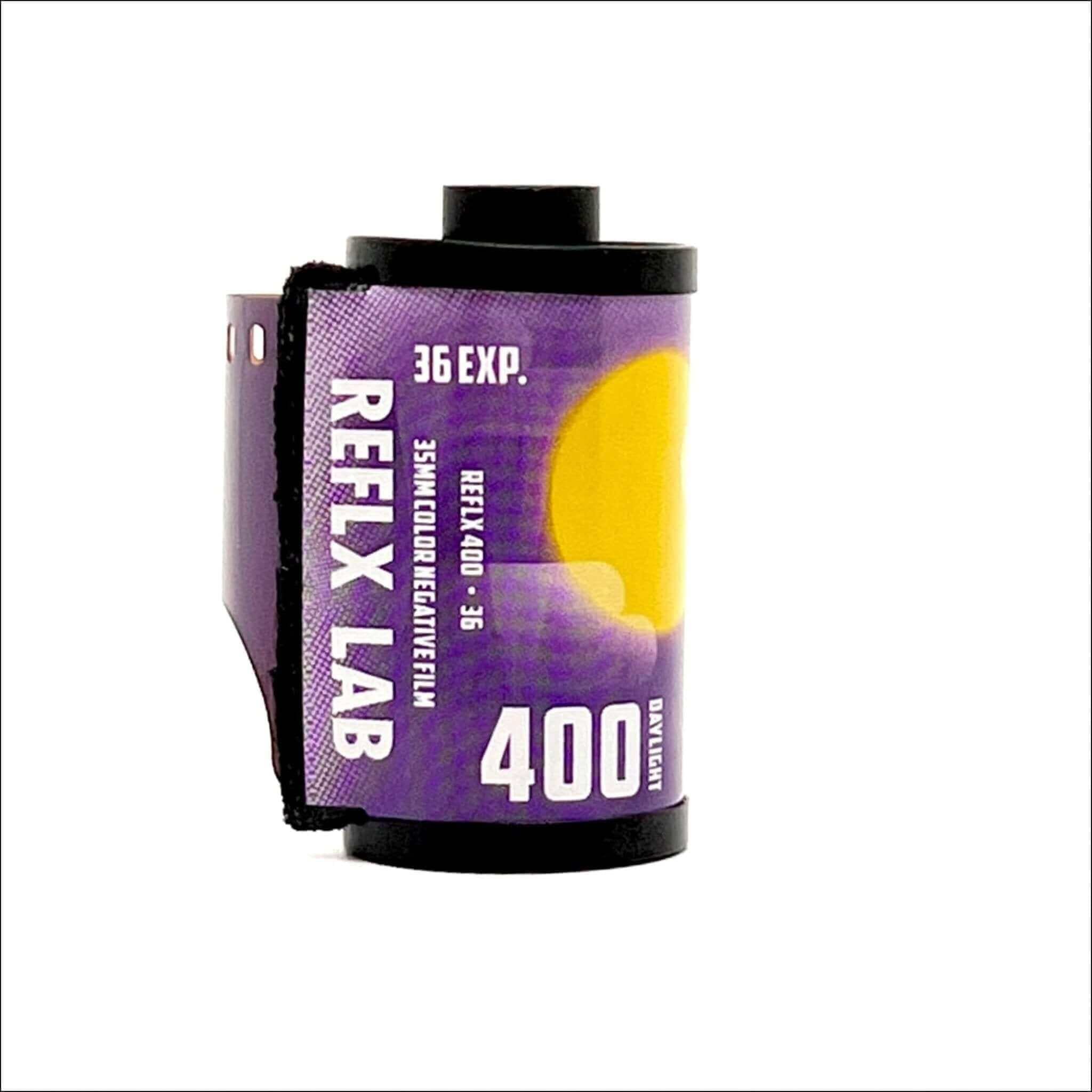 Purple reflex lab 35mm color negative film canister with a yellow sun graphic and black plastic ends.