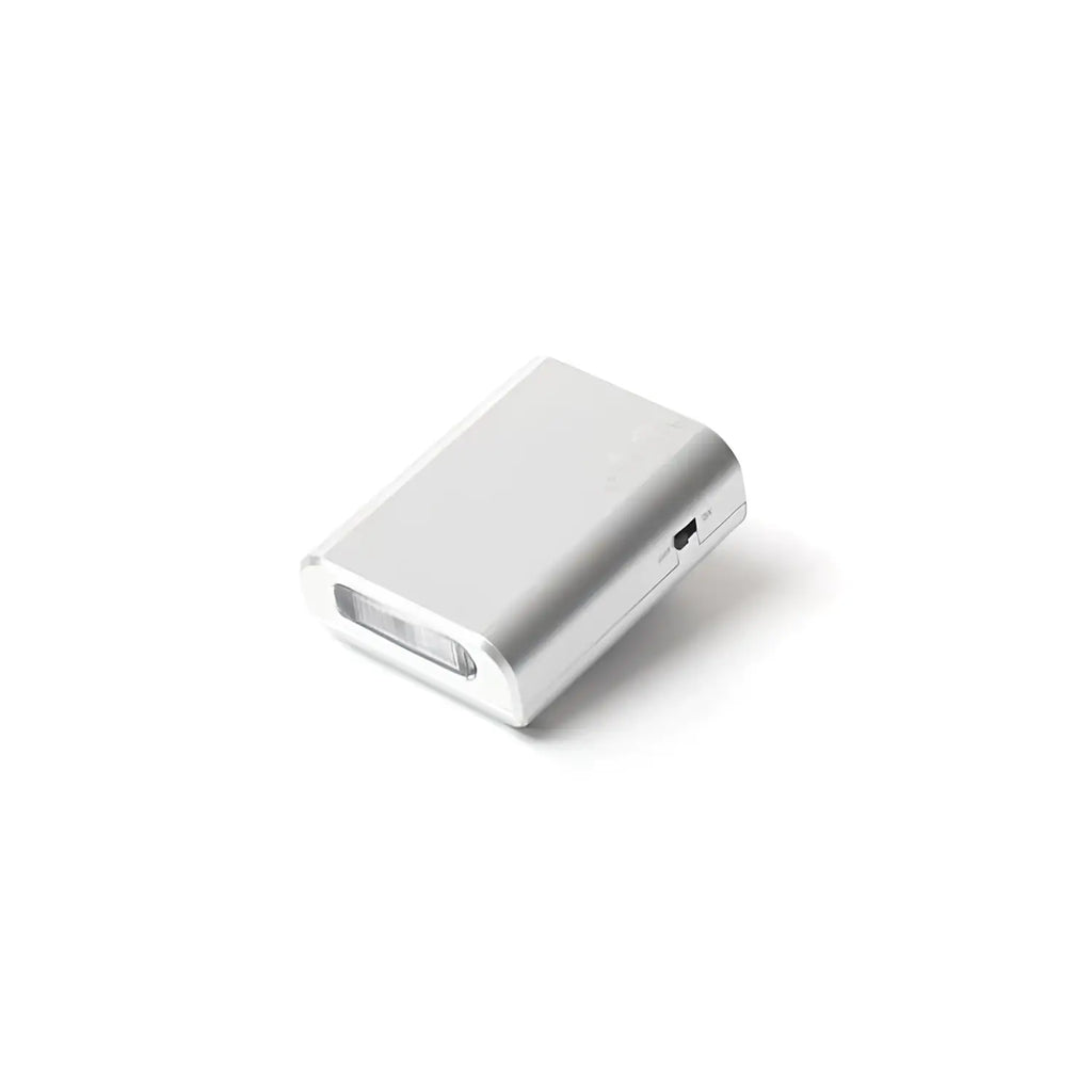 Silver rectangular portable phone charger with a usb port and an integrated led light on the front.