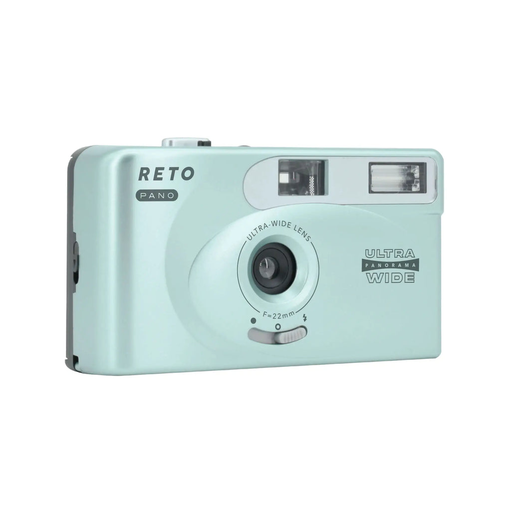 Mint green plastic compact camera with silver accents and ’reto pano’ branding.