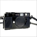 Black zeiss ikon rangefinder camera with textured leather grip and chrome accents.
